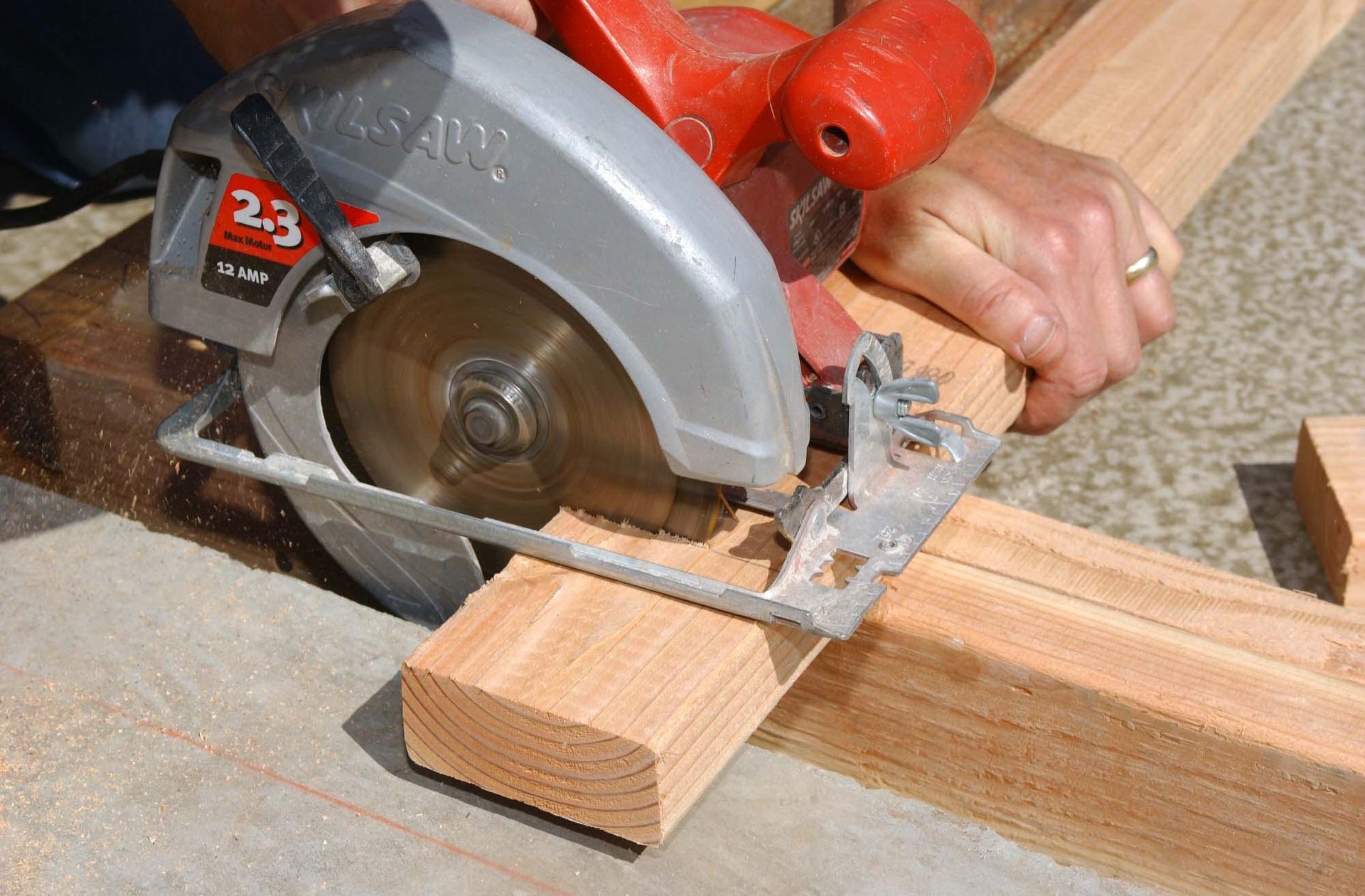 Cutting wood with a saw.