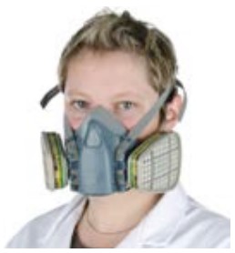A person wearing a reusable half mask breathing apparatus with a gas / vapour filter.