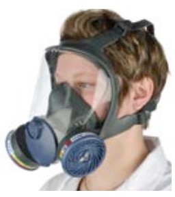 A person wearing a full face mask breathing apparatus with a gas / vapour filter .