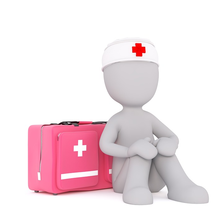 A cartoon figure wearing a white headband with a red cross on it next to a pink first aid box.
