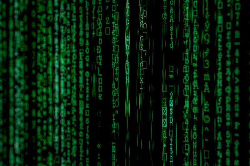 Sequences of green computer code against a black background.