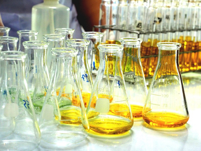 Numerous chemical test tubes of which some were empty and some with yelllow-coloured liquid in it.