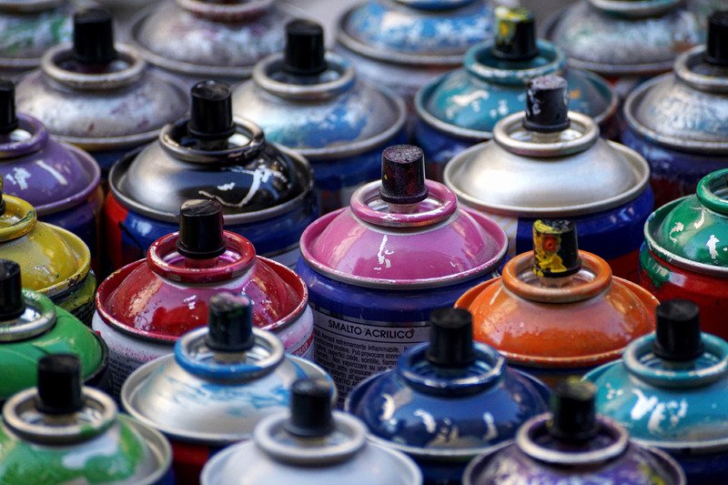 Different coloured spray painting cans.