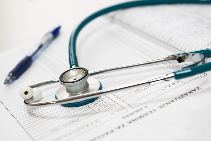 A stethoscope and pen on top of a piece of paper.