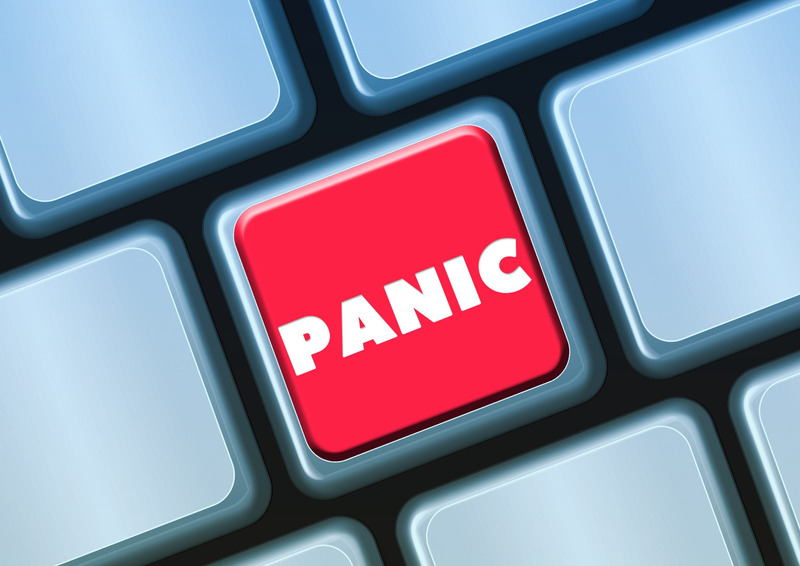 A red button on a keyboard reading 'PANIC' in white letters.