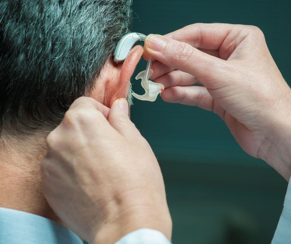 Man having a hearing aid fitted
