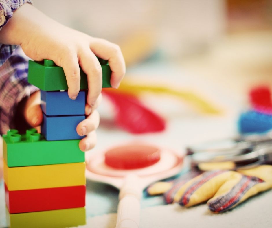 Child playing with lego blocks