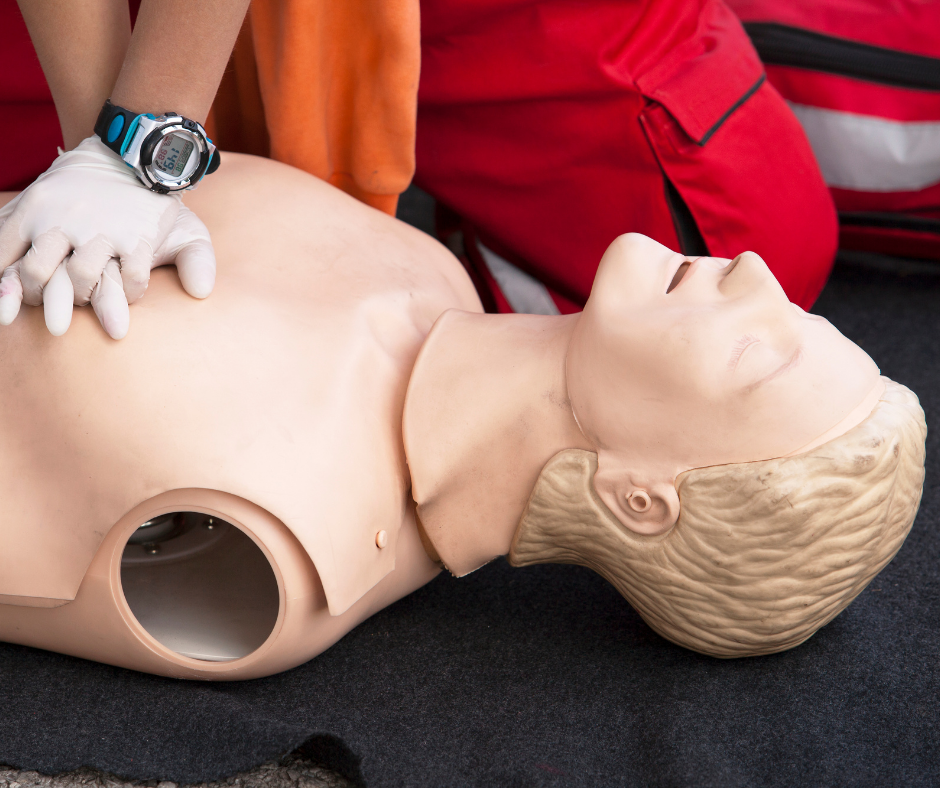 First aid trainee giving cpr to a dummy