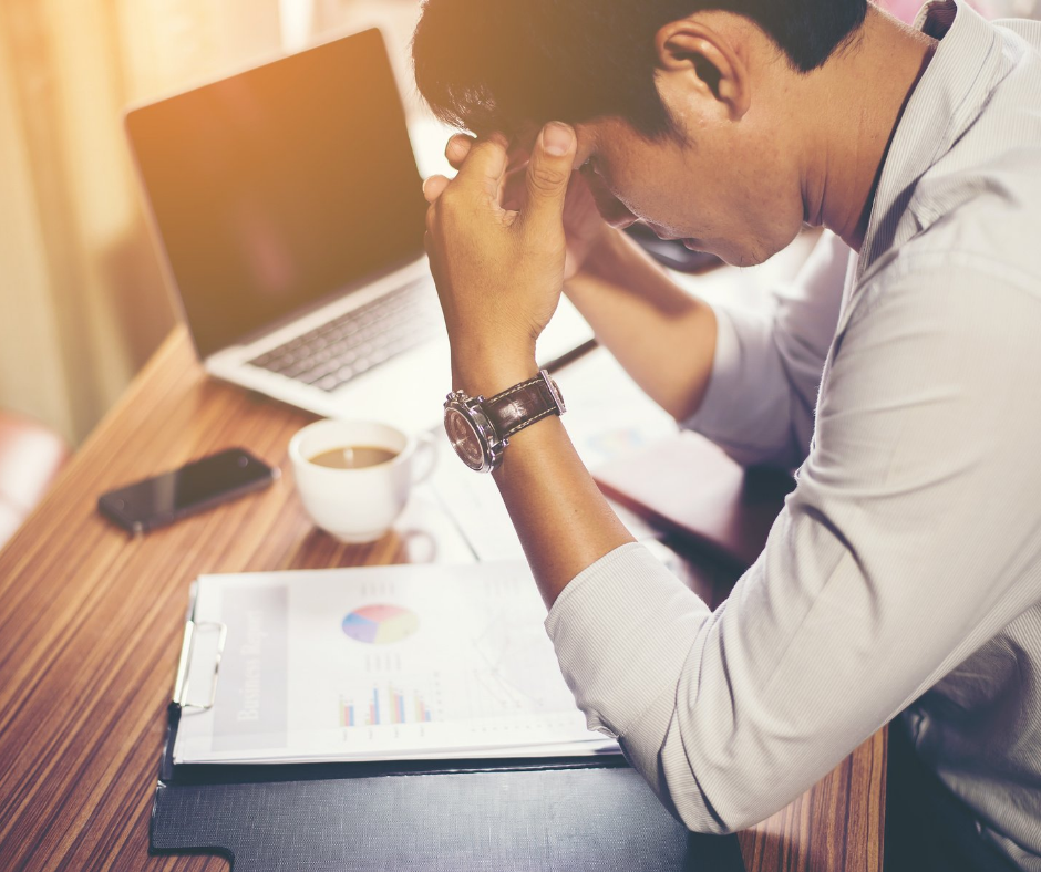 Man stressed at work desk