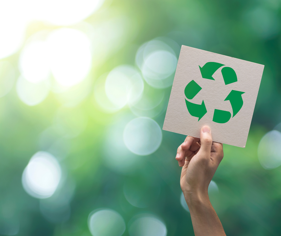 Hand holding a recycling sign