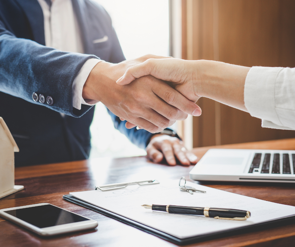 Handshake over papers