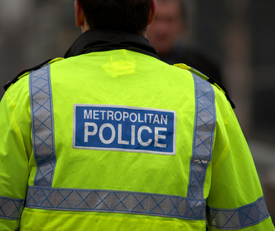 The back of someone wearing a metropolitan police jacket