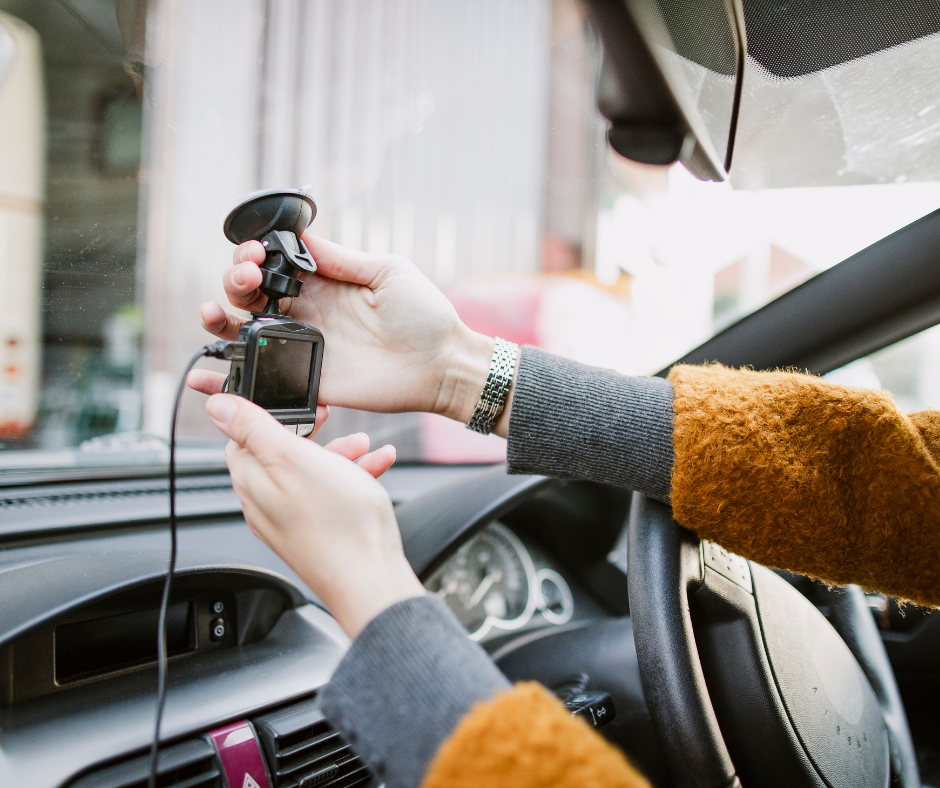 Hands setting up a satnav in a car