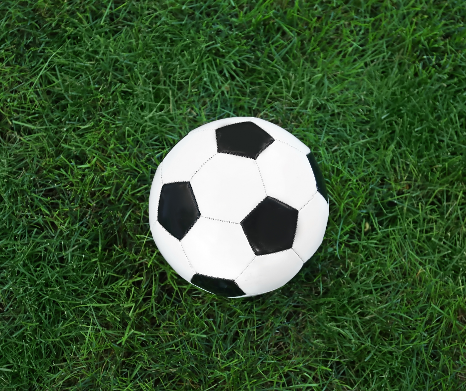 Black and white football on grass