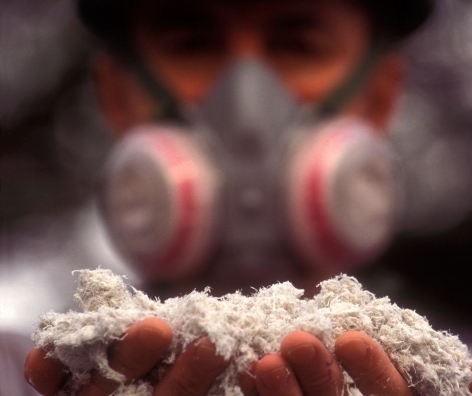 Worker wearing respiratory mask holding asbestos