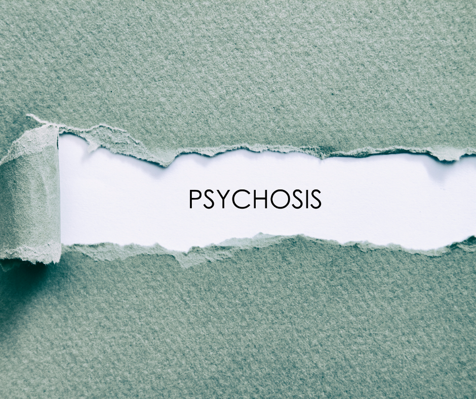 Green paper ripped to reveal the word 'psychosis'