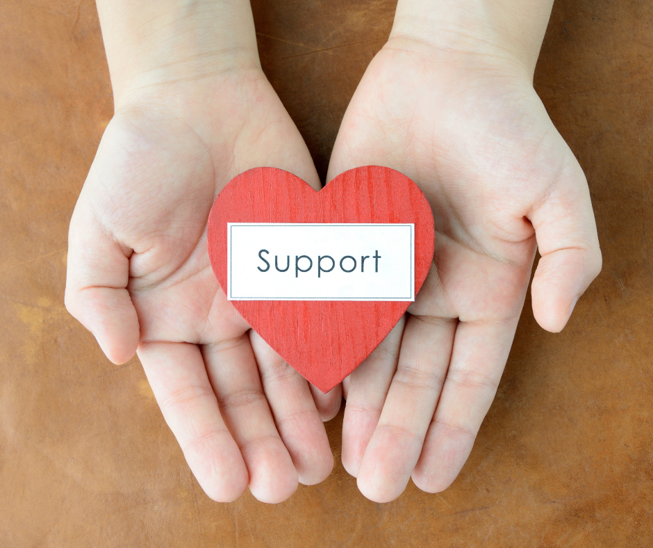Hands holding a heart that says 'support'