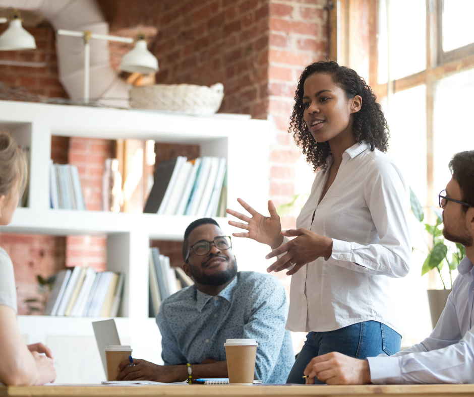 Woman speaking to a group of colleagues