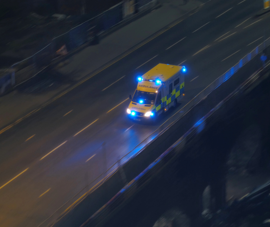 Aerial view of an ambulance on a motorway at night