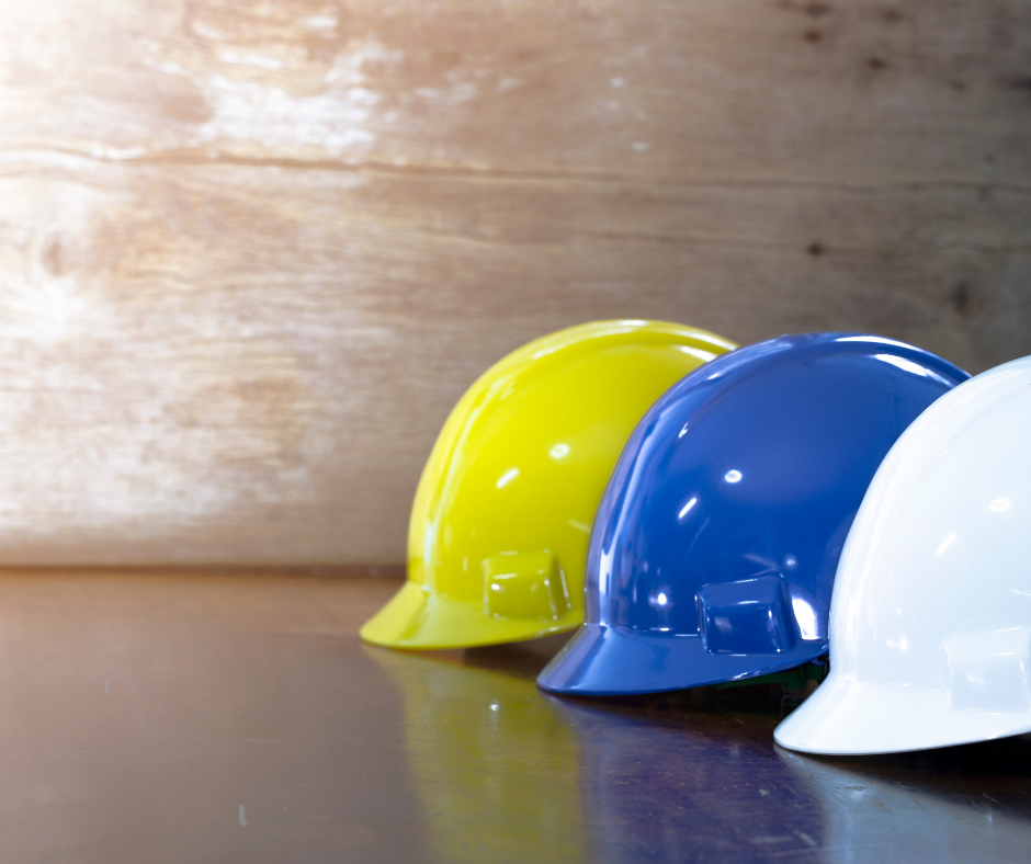 yellow blue and white safety helmets in a line