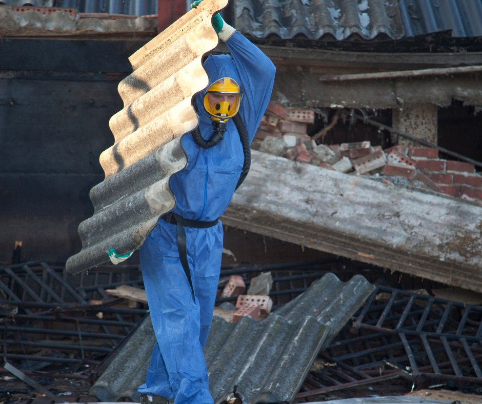 Man in ppe carrying asbestos panel