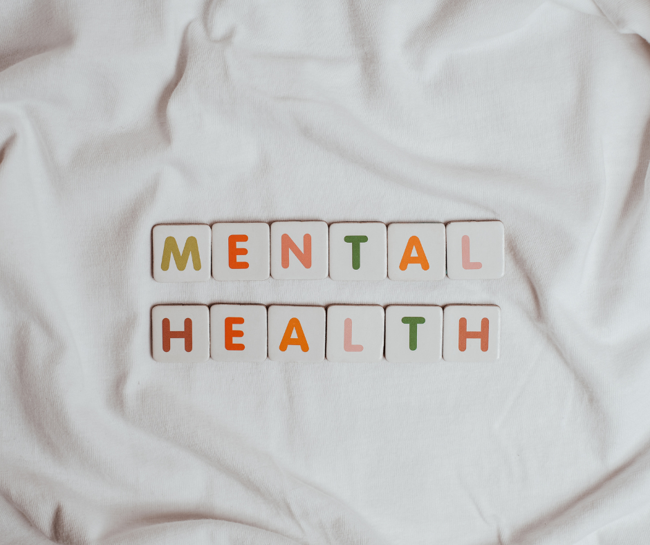 'Mental health' spelled out in letter tiles on a white sheet