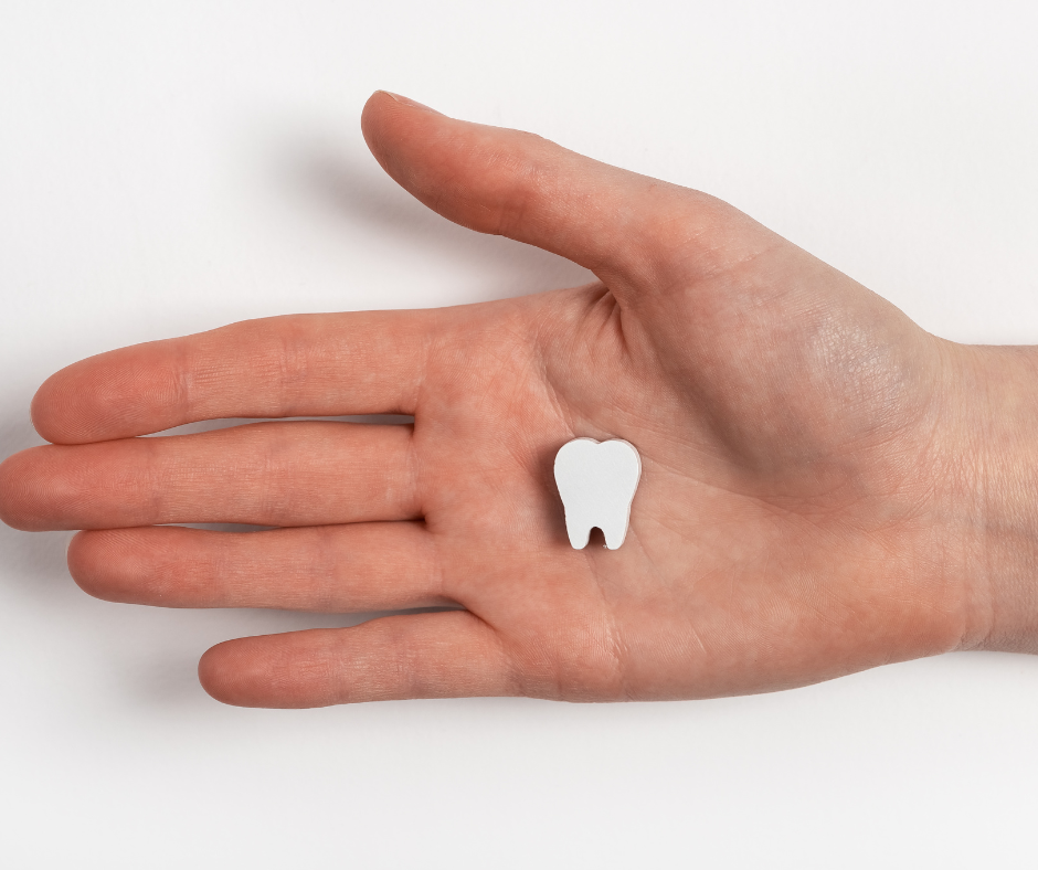 Tooth in the palm of a hand