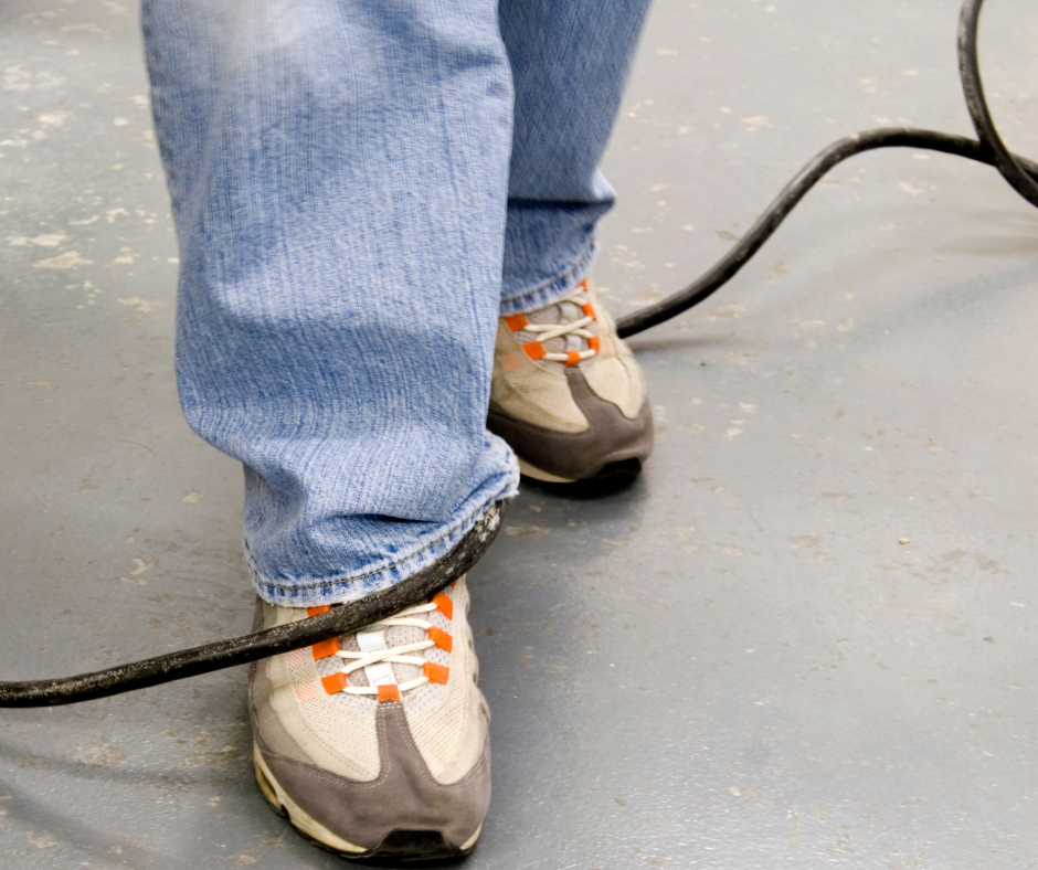 Foot under a cord, about to trip