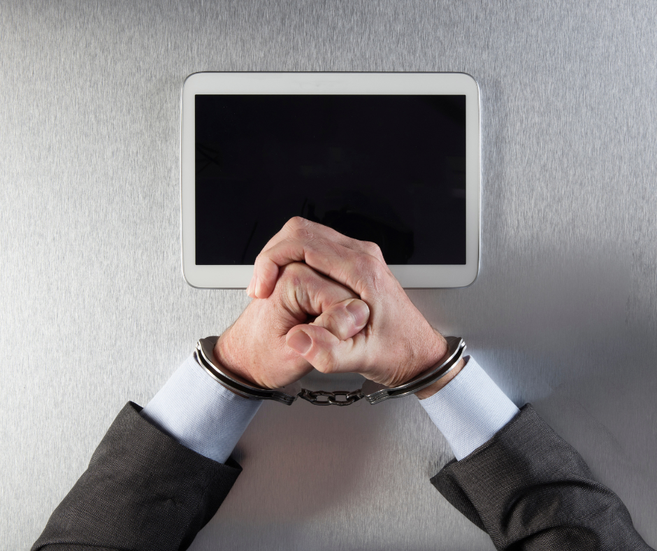 Arms in a suit wearing handcuffs