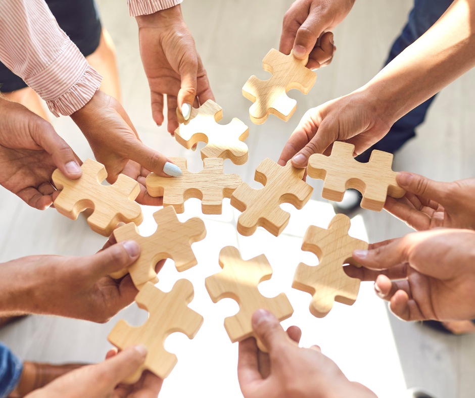 Hands holding puzzle pieces