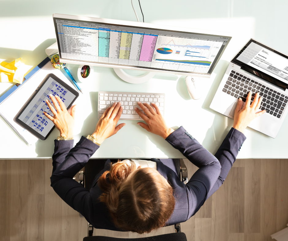 Person with four arms multitasking on multiple computers