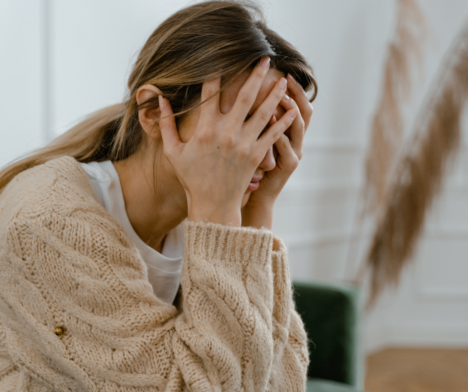 stressed woman holding her head