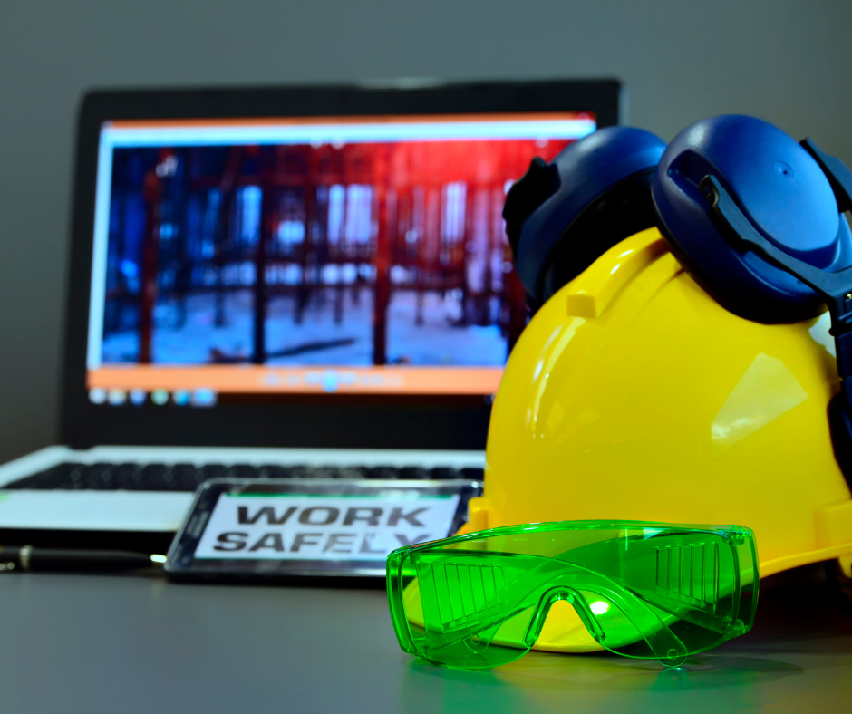 safety goggles and helmet in front of a laptop