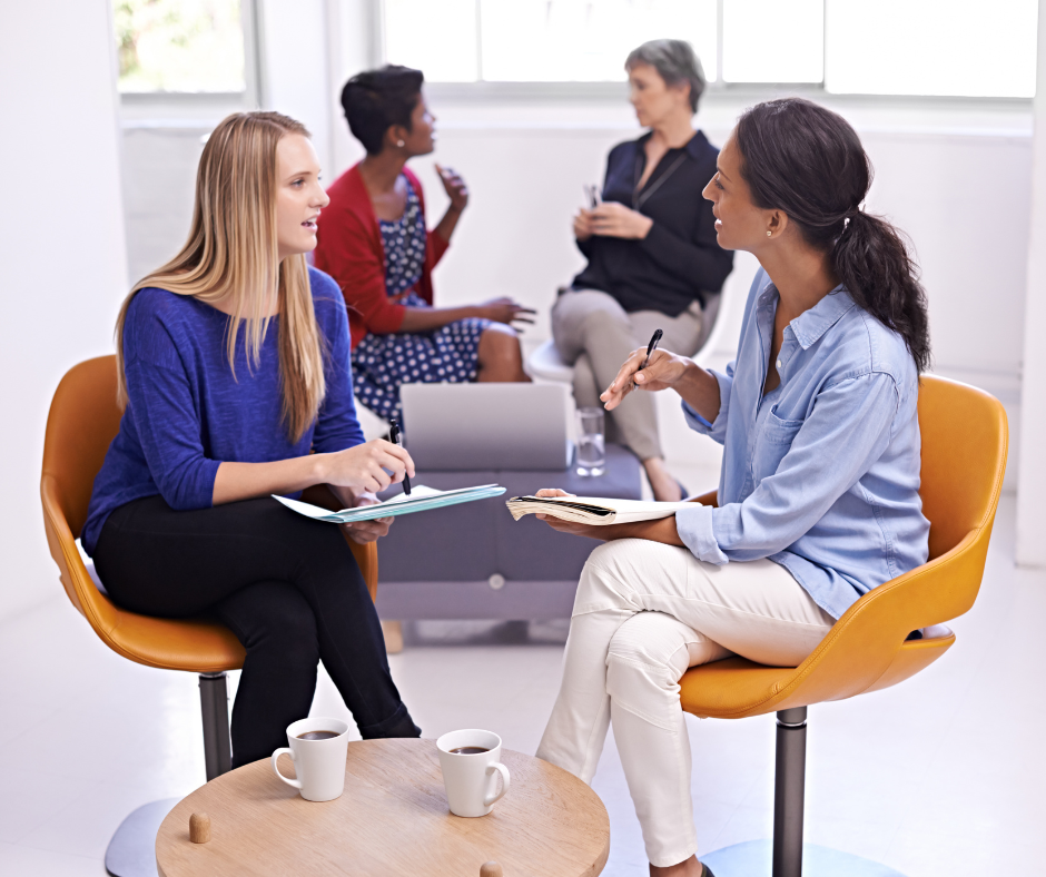 group of women talking at work