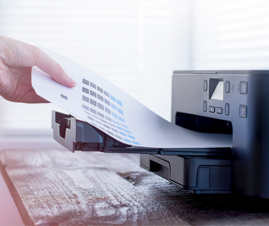 hand taking a printout out of a printer