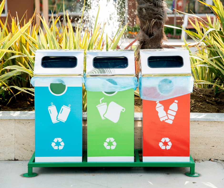 three recycling bins, blue green and red, with symbols on them correlating to what they should be used for