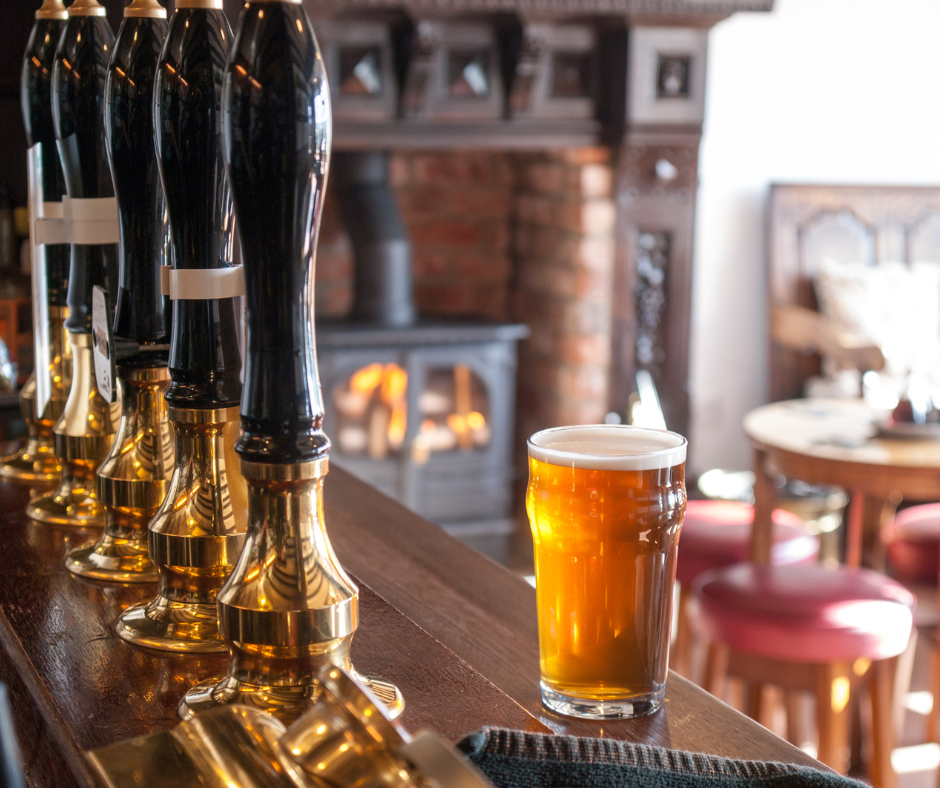 the bar at a pub with a beer on it